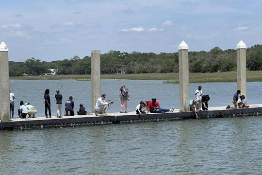 Children fishing on a dock in Charleston, South Carolina