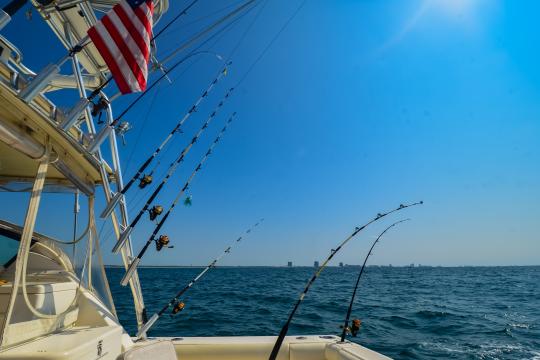 Saltwater fishing boat with poles in the Gulf of Mexico, Alabama.