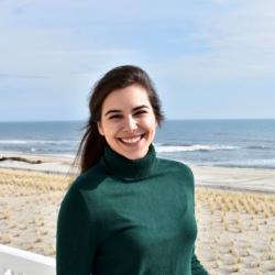 Gabriellla standing on the beach. 