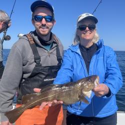 Alex Hansell, stock assessment scientist with the Northeast Fisheries Science Center, and NOAA Fisheries Assistant Administrator Janet Coit hold an Atlantic cod