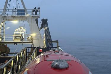 Aft view of a NOAA chartered survey vessel showing calm seas.