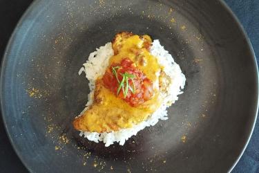 Curried skate wings plated with rice and chutney