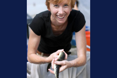 Woman holding an eel in her hands