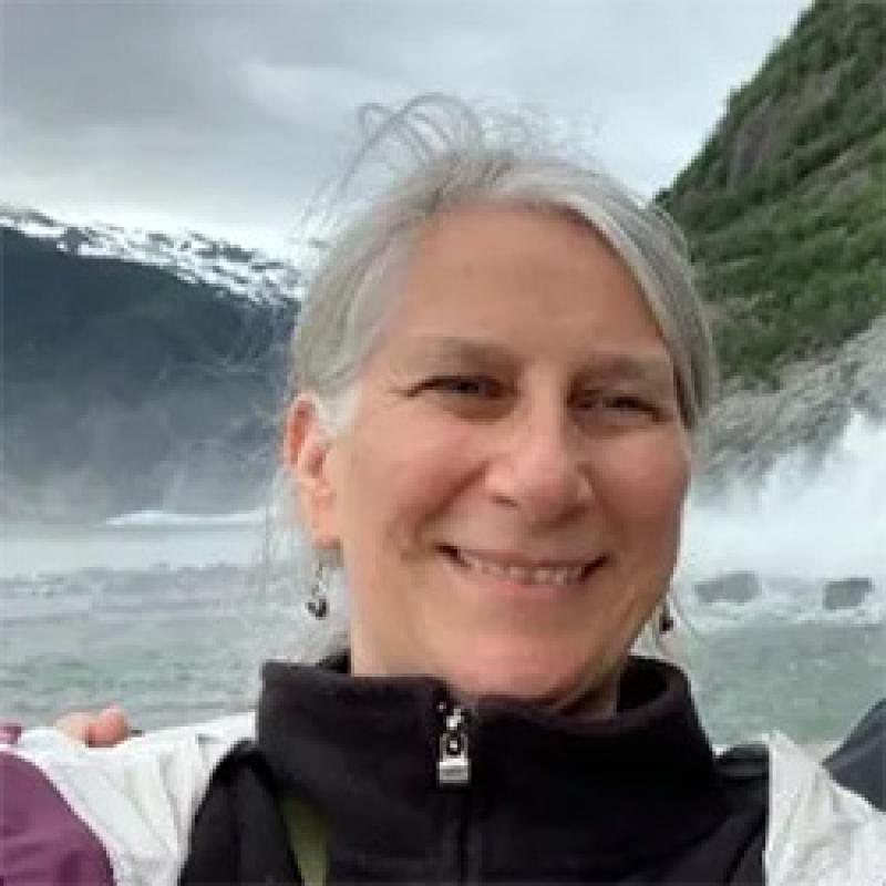 Portrait of scientist with a lake and mountains in background